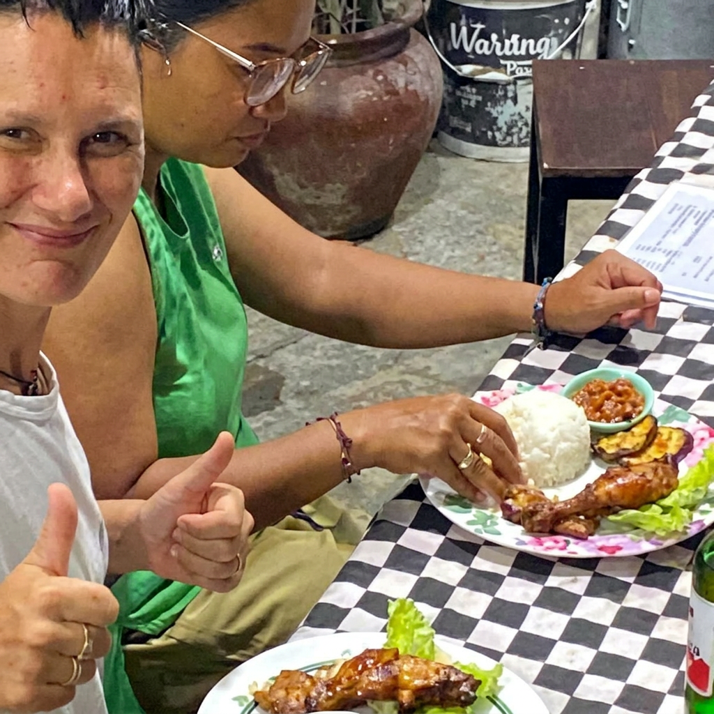 Happy guests sharing a meal at Warung Pax