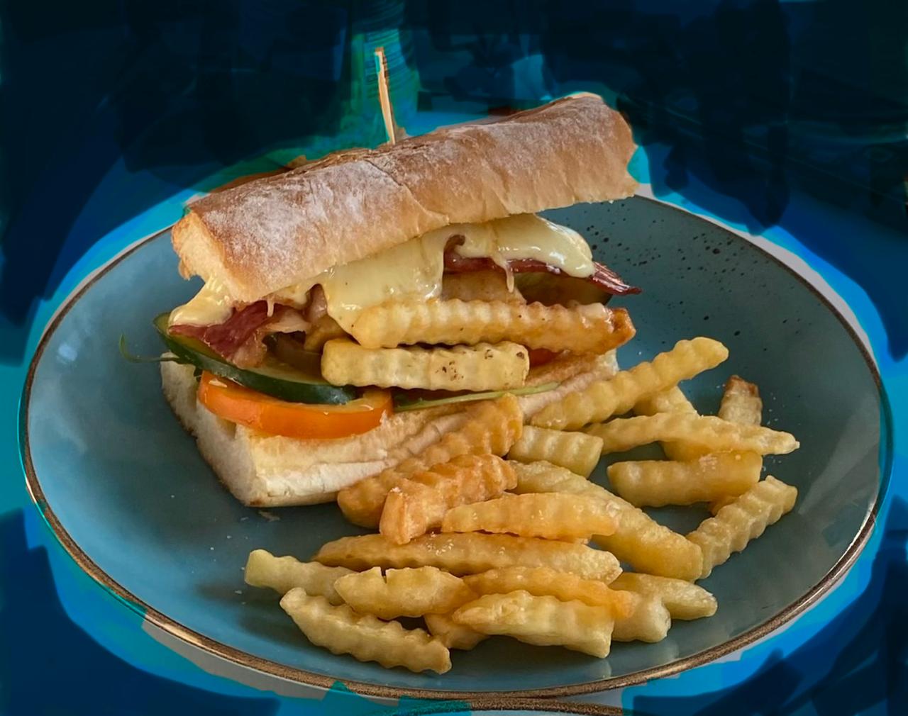 Ciabatta panino with melted cheese and crinkle fries